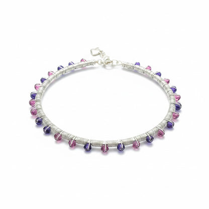 Jena Jewelry handmade wire-wrapped bangle bracelet with pink and purple glass crystals on a silver-tone wire base.
