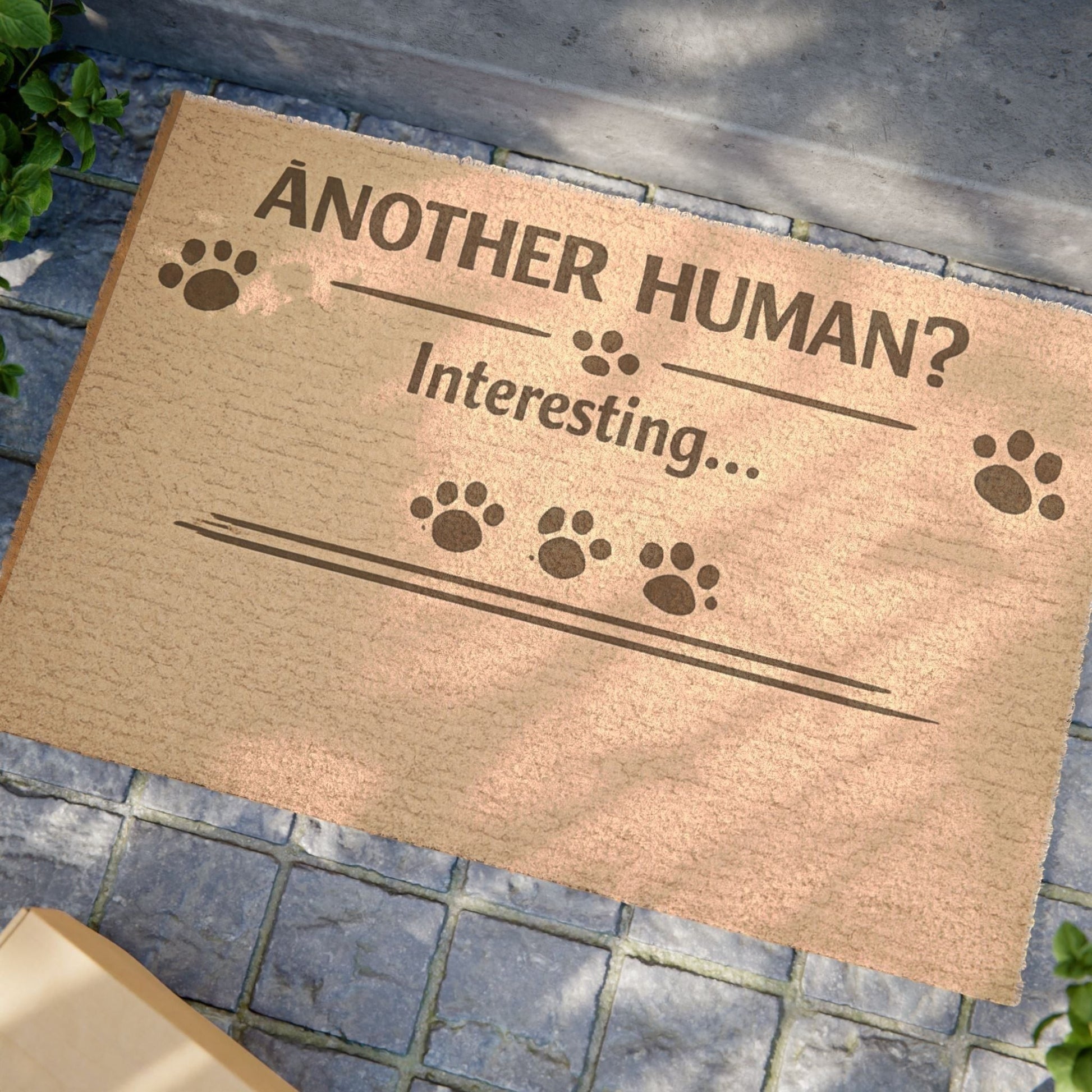 Close-up angled view of “Another Human? Interesting…” cat doormat, highlighting playful design and witty message.