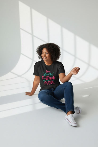 Woman sitting wearing black “Drop the F-Bomb Mom” t-shirt, a sleek and edgy look.