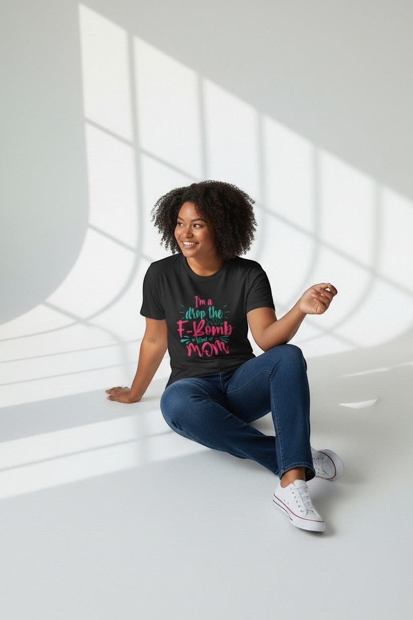 Woman sitting wearing black “Drop the F-Bomb Mom” t-shirt, a sleek and edgy look.