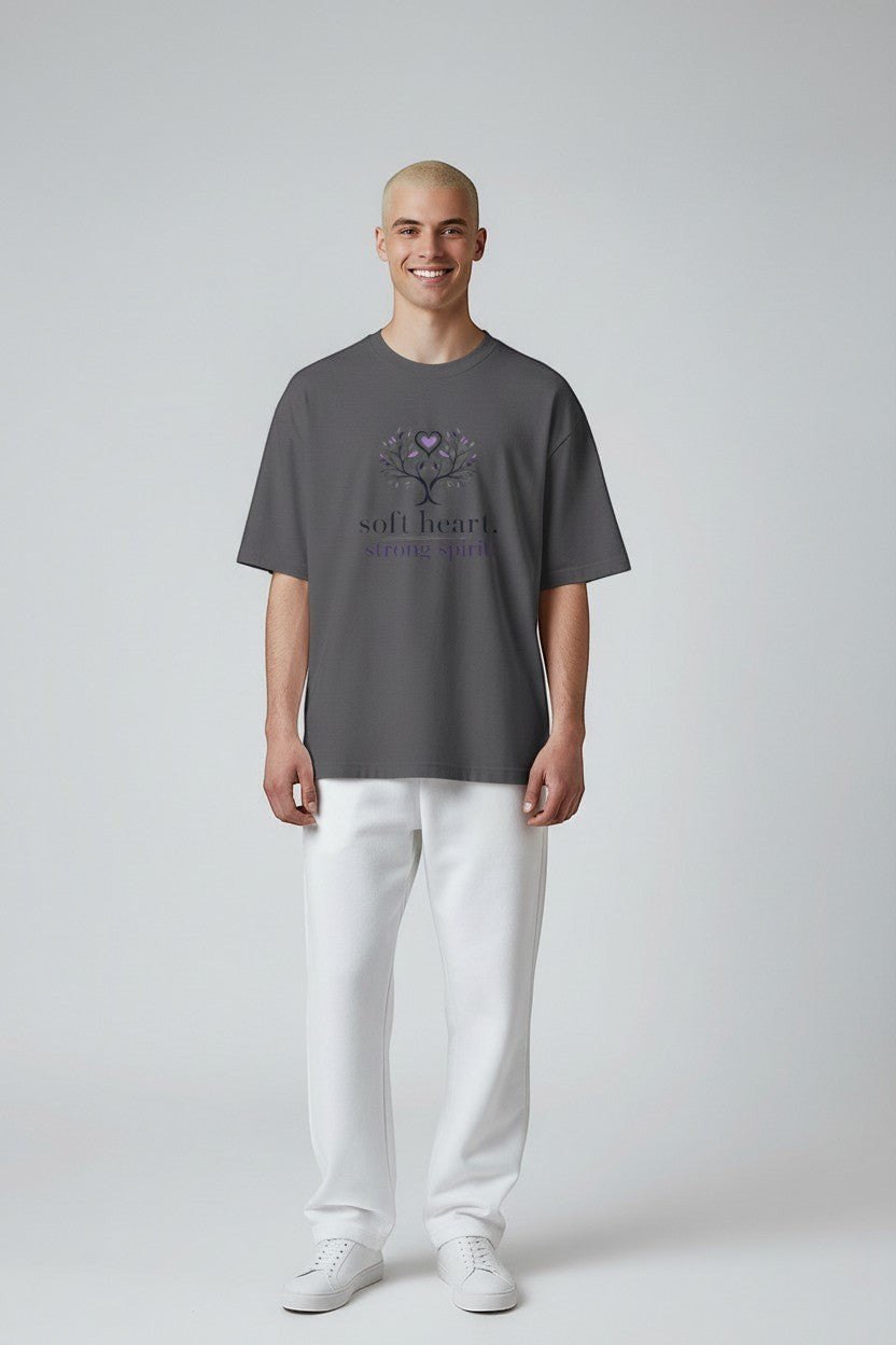 Model wearing charcoal grey “Soft Heart Strong Spirit” t-shirt, a simple and meaningful everyday graphic tee.