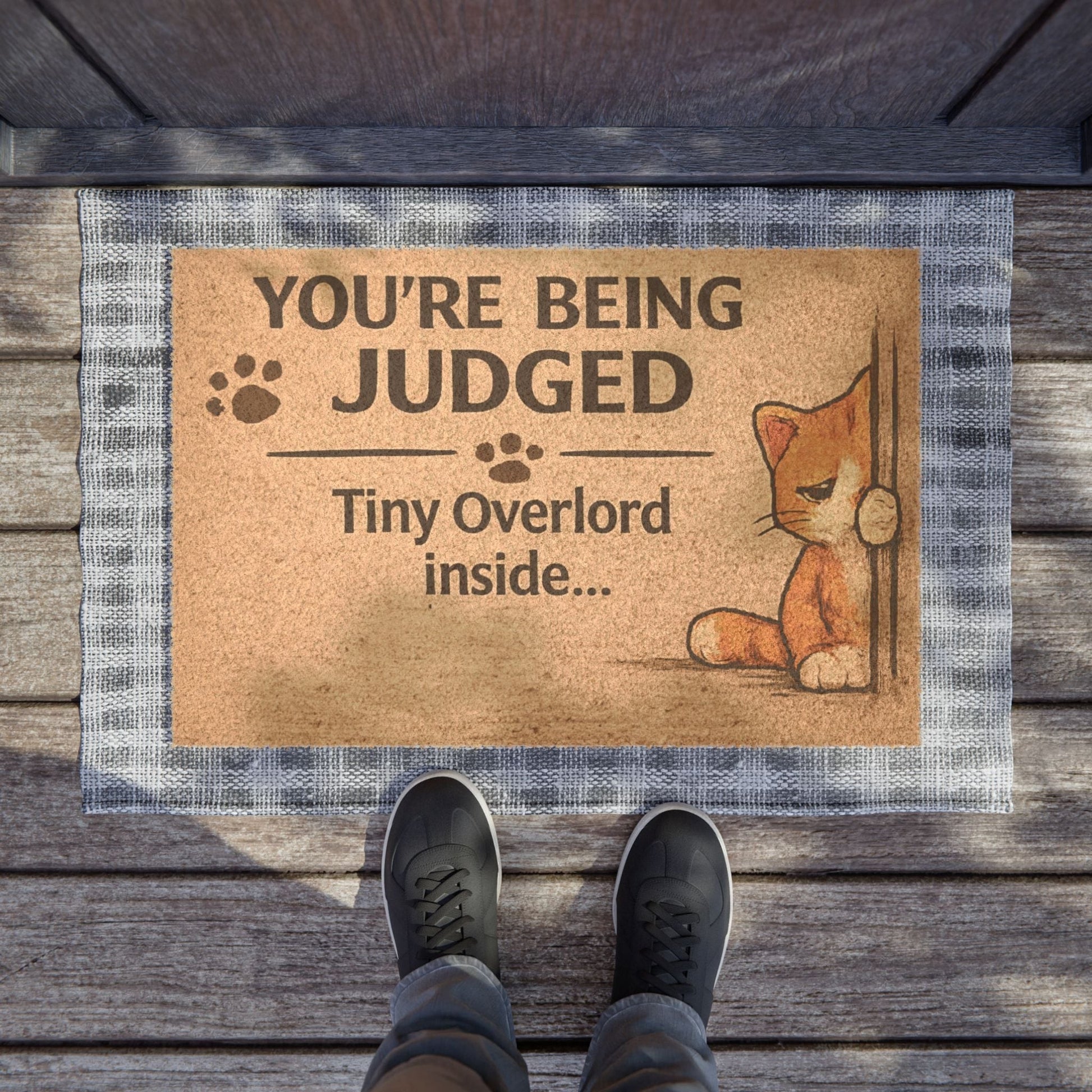Top view of humorous cat doormat with “You’re Being Judged” message, ideal for adding personality to your entryway.