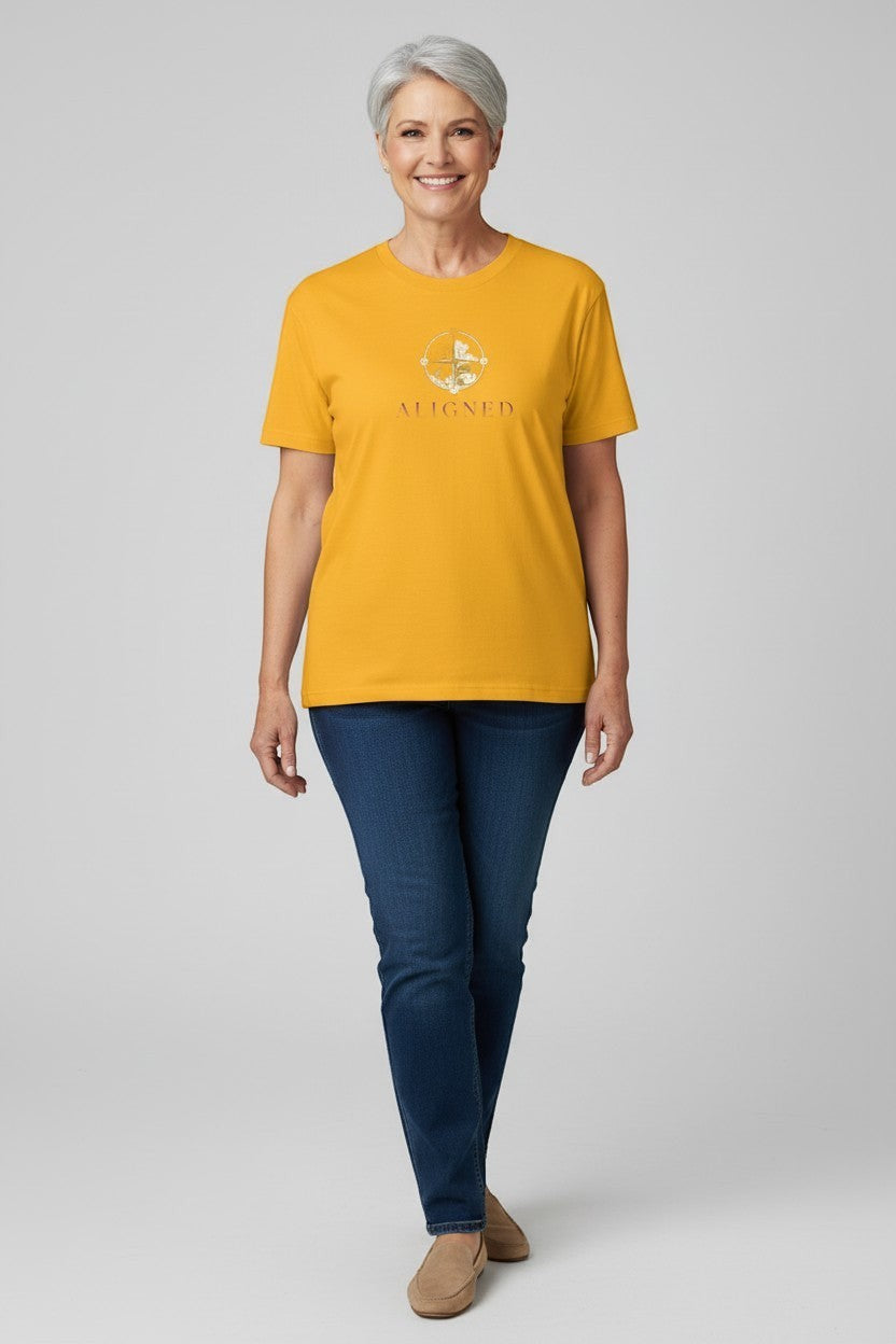 Woman wearing gold “Aligned” t-shirt, a bright and uplifting mindful look.