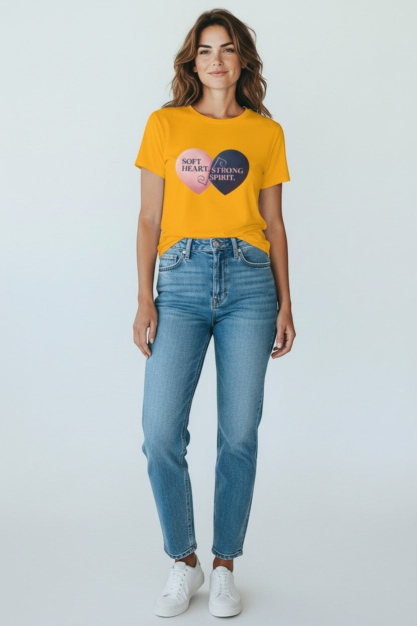 Woman wearing gold “Soft Heart Strong Spirit” t-shirt, a bright and positive everyday look.