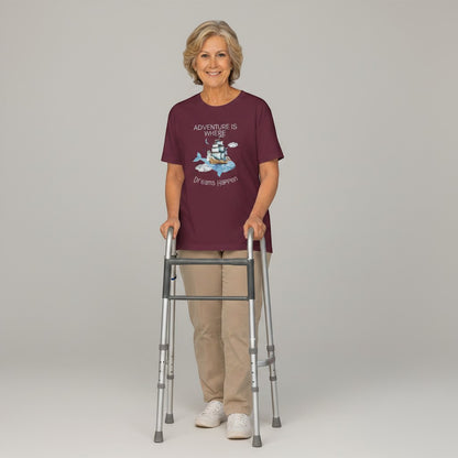 Jena Jewelry maroon cotton graphic tee with whale, ship, lighthouse, and clouds. Features quote "Adventure Is Where Dreams Happen".
