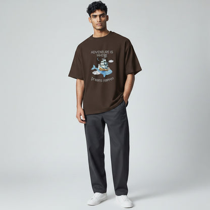 Jena Jewelry brown cotton graphic t-shirt with whale, ship, lighthouse, and clouds. Quote: Adventure Is Where Dreams Happen.