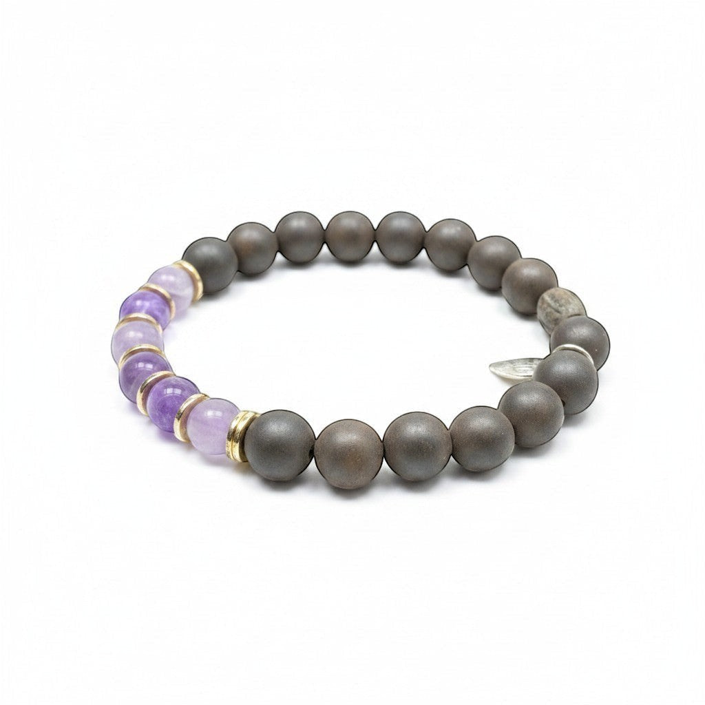 Jena Jewelry stretch bracelet with amethyst, ebony mala beads, and hematite, accented with gold spacers.
