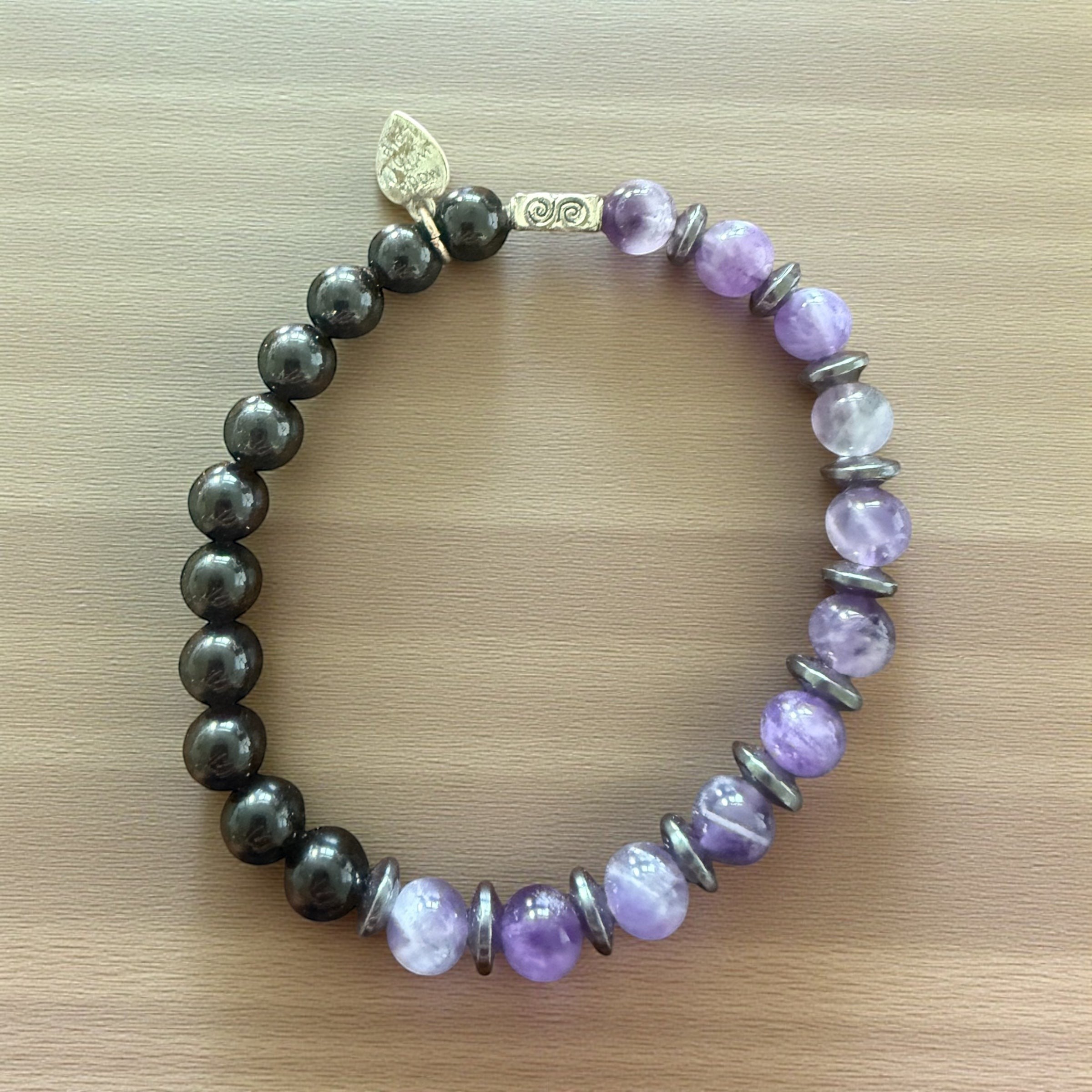 Jena Jewelry amethyst, hematite, and black onyx beaded stretch bracelet with silver accent beads and a leaf charm.