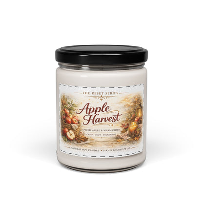 Jena Jewelry Apple Harvest soy candle with spiced apple and warm cider scent, featuring a cozy fall scene with apples and a lantern.