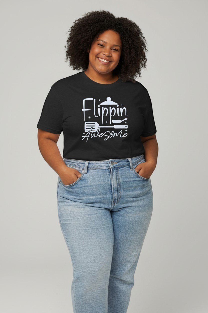 Jena Jewelry black 100% cotton t-shirt with a white graphic that says "Flippin Awesome" with spatula and pan icons.