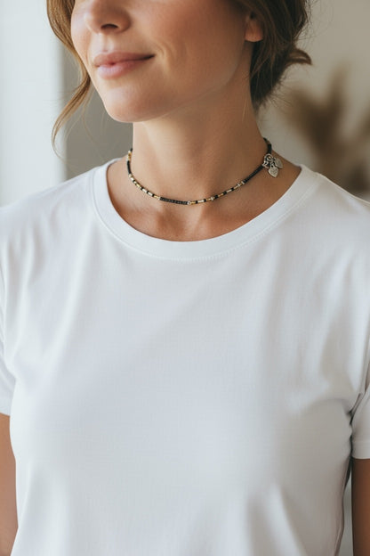 Jena Jewelry black seed bead choker necklace with gold accents and heart charms.