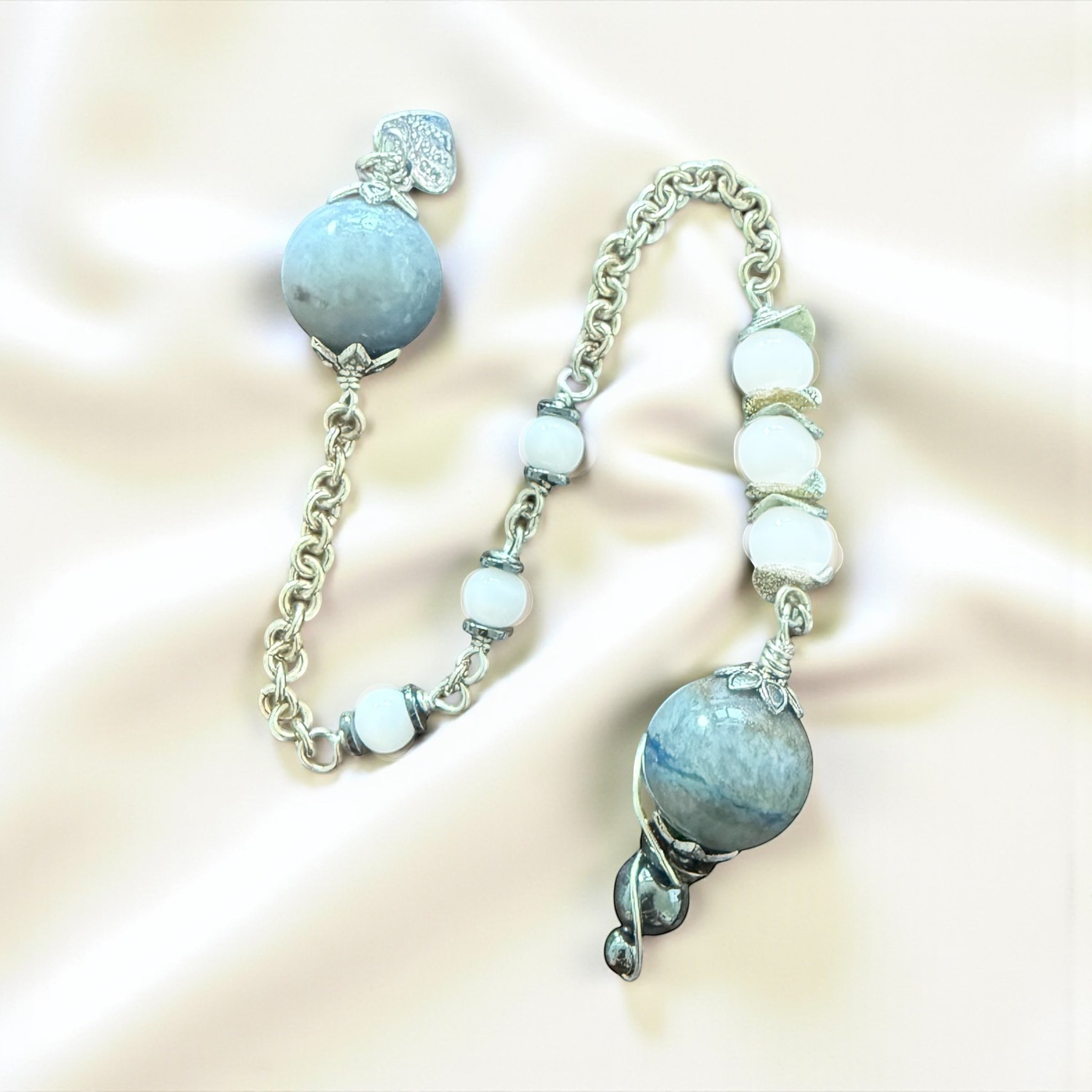 Jena Jewelry pendulum with blue aventurine, snow jade, and hematite beads on a silver chainmaille handle.
