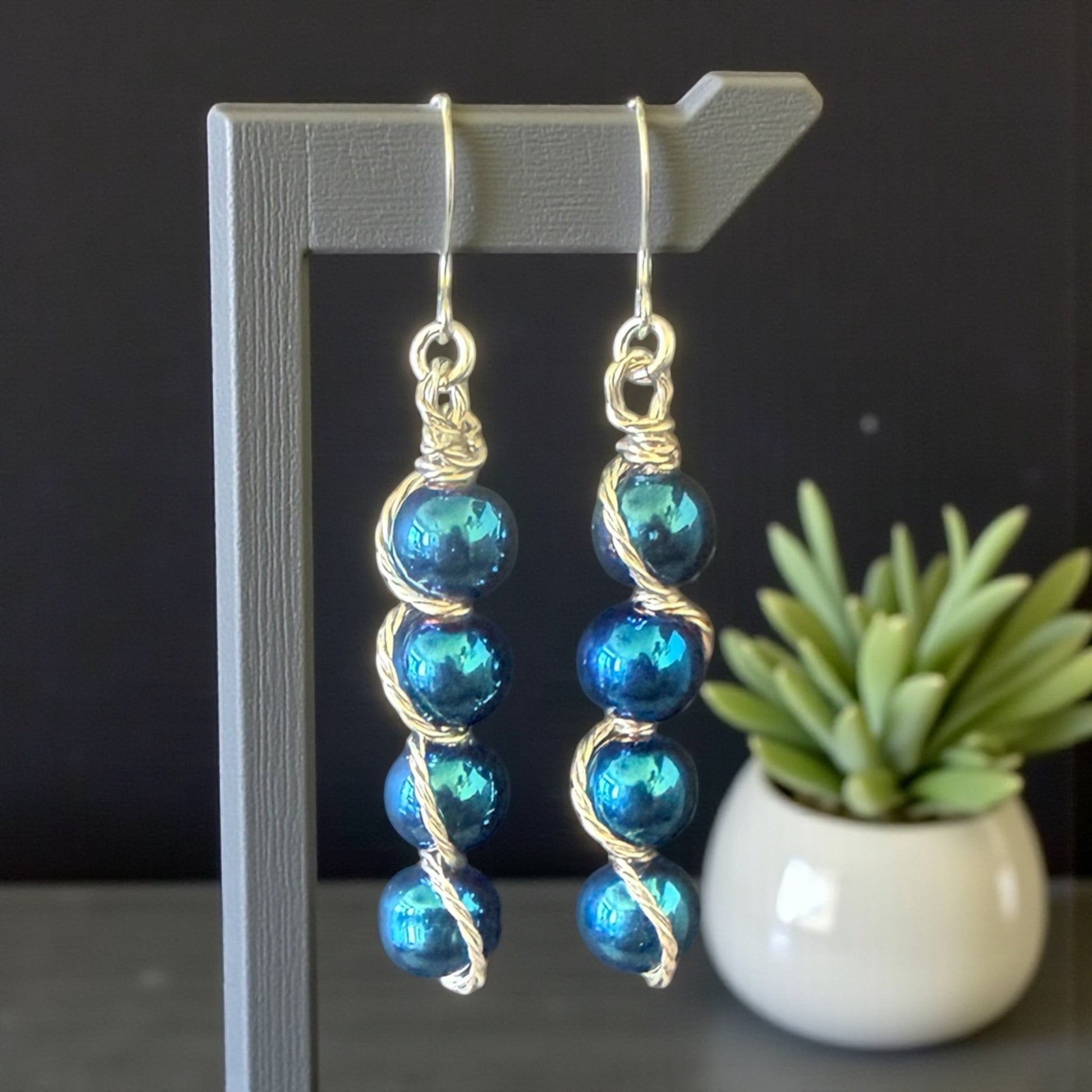 Jena Jewelry stacked drop earrings with iridescent blue beads and silver-tone wire wrapping. Hypoallergenic ear wires.