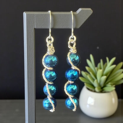 Jena Jewelry stacked drop earrings with iridescent blue beads and silver-tone wire wrapping. Hypoallergenic ear wires.