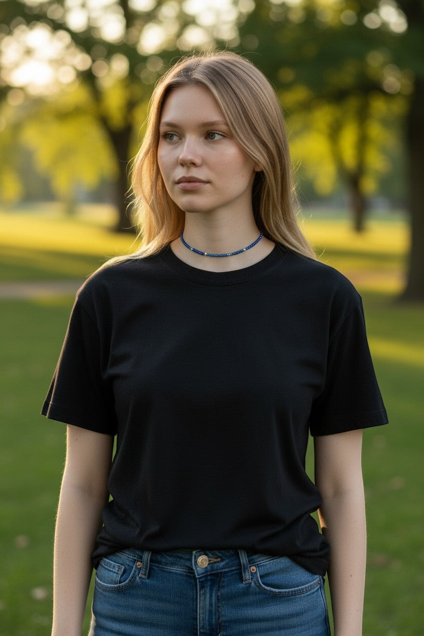 Jena Jewelry handcrafted blue seed bead choker necklace with silver accents on a young woman wearing a black t-shirt outdoors.