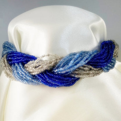 Jena Jewelry multi-strand braided necklace with glass seed beads in shades of blue and silver.
