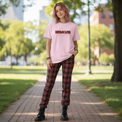 Jena Jewelry pink 100% cotton crewneck t-shirt with bold red "BRAVE" graphic and smaller text "LOOKS GOOD ON YOU".