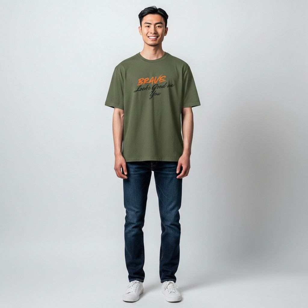 Jena Jewelry olive green cotton t-shirt with orange and black text that reads "BRAVE Looks Good on You".