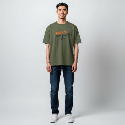 Jena Jewelry olive green cotton t-shirt with orange and black text that reads "BRAVE Looks Good on You".