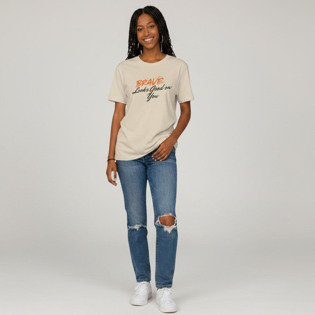 Jena Jewelry cream cotton t-shirt with "BRAVE Looks Good on You" graphic print. Short sleeves, crew neck.