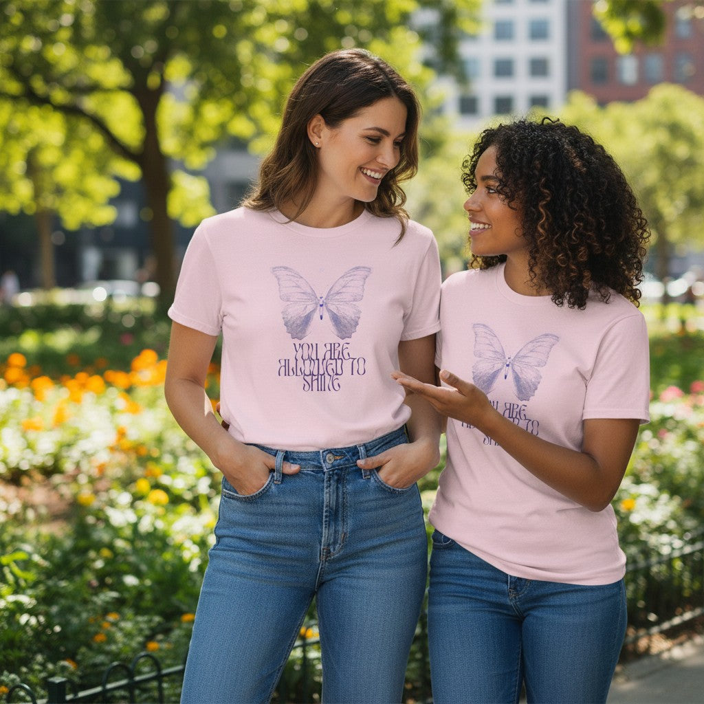 Jena Jewelry light pink 100% cotton t-shirt with a watercolor butterfly graphic and "You Are Allowed to Shine" text.