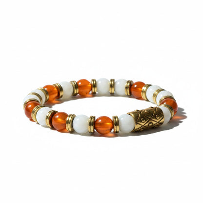 Jena Jewelry handmade stretch bracelet with carnelian, snow jade, and hematite beads, featuring a central ornate gold-tone bead.
