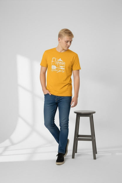 Jena Jewelry men's mustard yellow 100% cotton t-shirt with 'Flippin Awesome' graphic and cooking icons.
