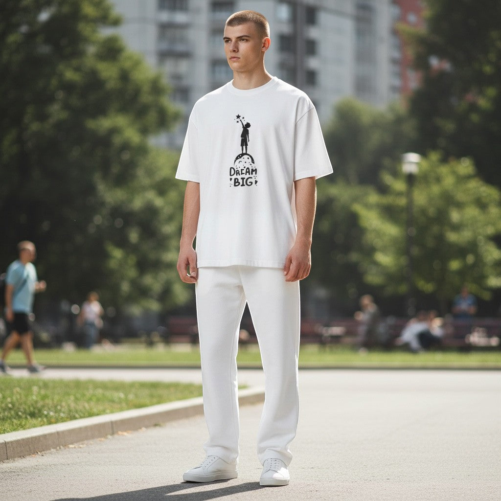 Jena Jewelry white cotton graphic t-shirt with "Dream Big" text and child reaching for stars graphic.