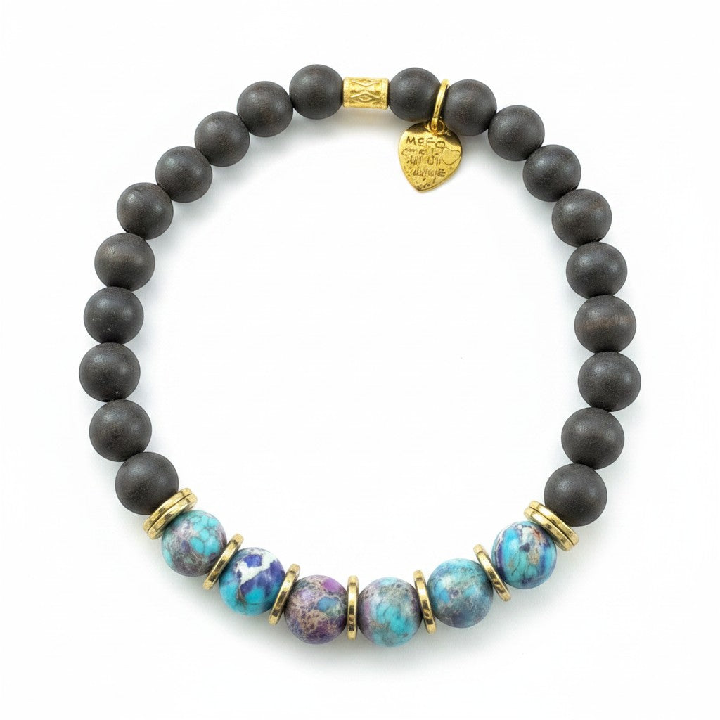 Jena Jewelry stretch bracelet with dark ebony wood beads, imperial jasper, and hematite accents, featuring a gold heart charm.