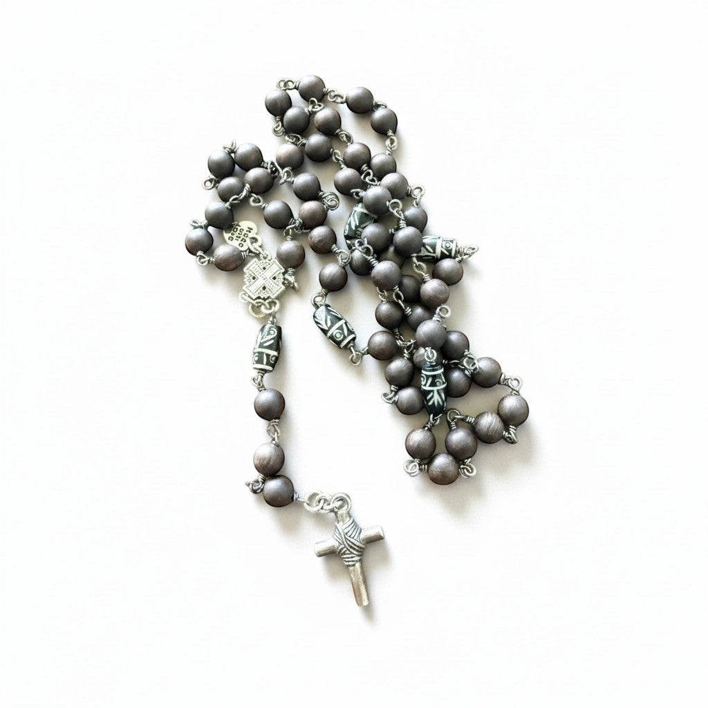 Jena Jewelry hand-wrapped rosary with ebony blackwood mala beads, hand-carved wood accent beads, and a base metal crucifix.