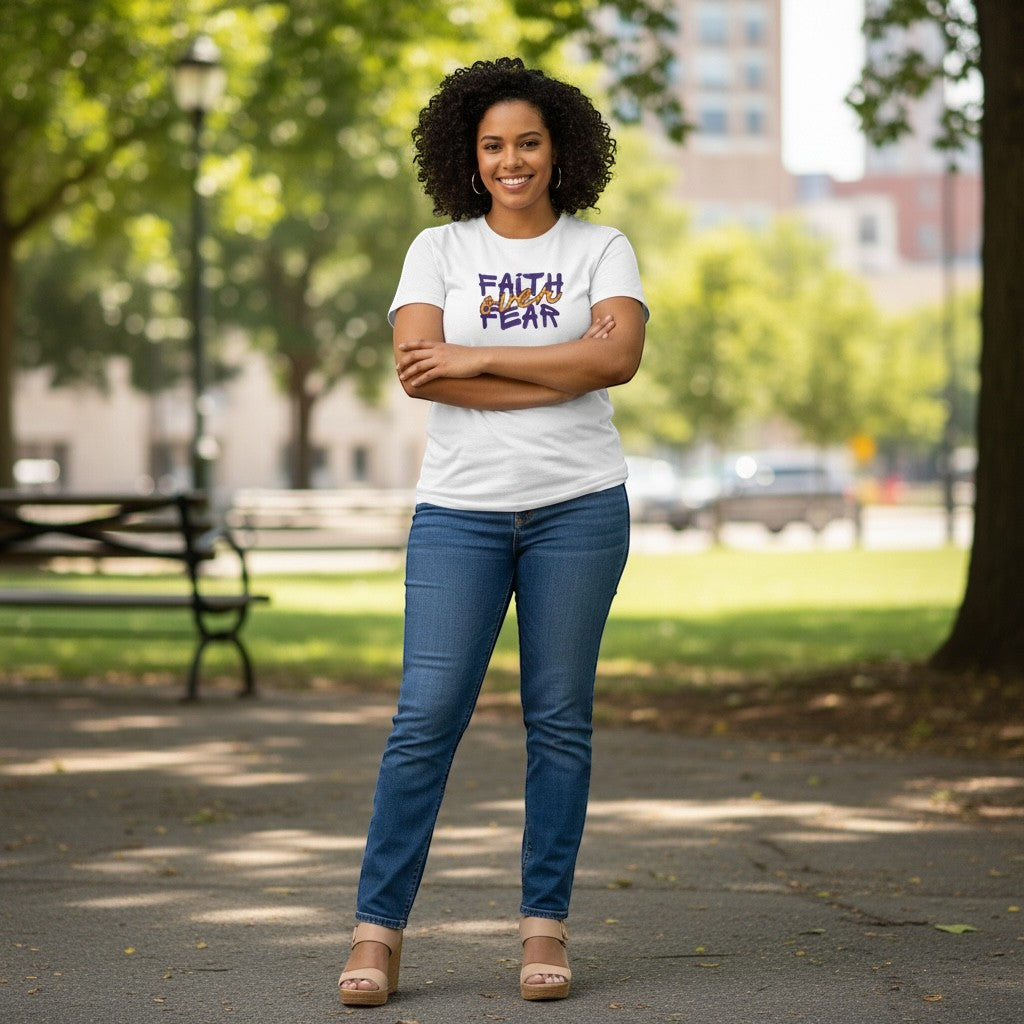 Jena Jewelry white cotton t-shirt with purple and orange "FAITH over FEAR" graphic, worn by a woman outdoors.