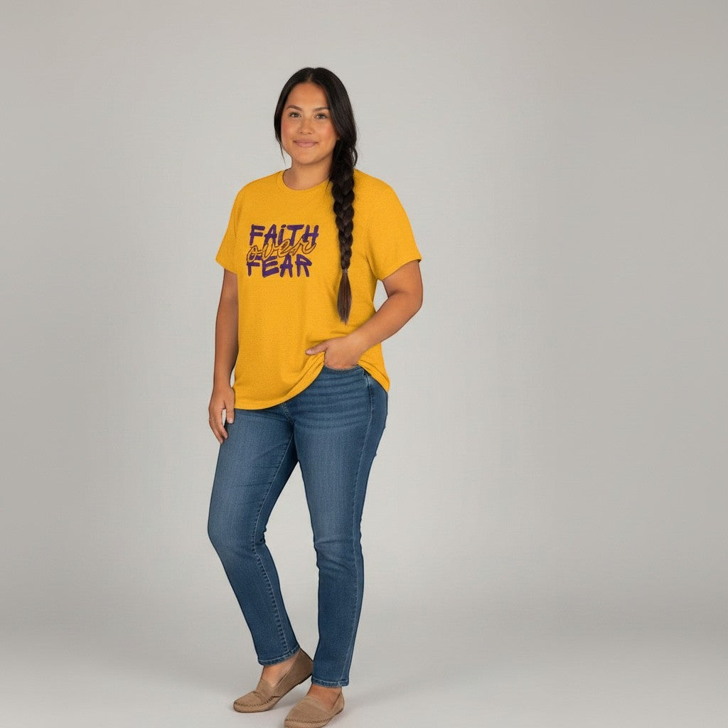 Jena Jewelry yellow cotton t-shirt with "FAITH over FEAR" graphic in purple and orange. Model wears jeans.