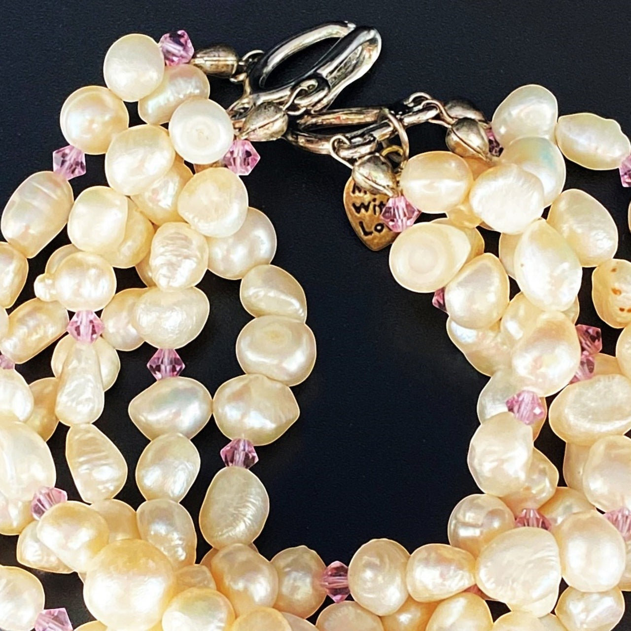 Jena Jewelry 6-strand freshwater pearl bracelet with pink crystals and silver clasp, perfect for bridal occasions.