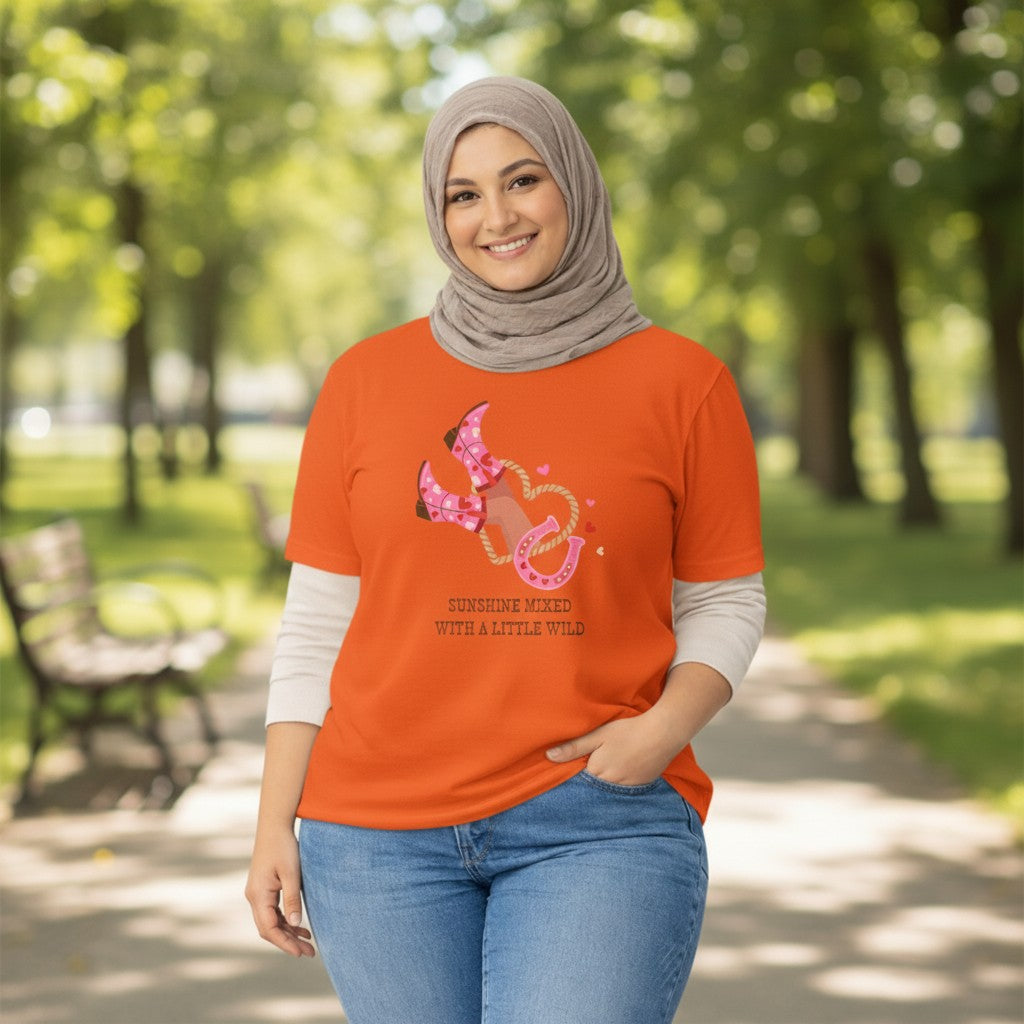 Jena Jewelry orange 100% cotton graphic tee with pink cowboy boots, lasso, horseshoe, and "Sunshine Mixed With A Little Wild" text.