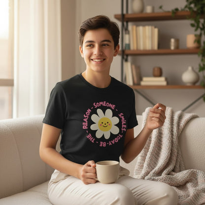 Jena Jewelry black 100% cotton graphic tee with a smiling daisy and "Be the Reason Someone Smiles Today" text.