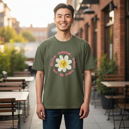 Jena Jewelry olive green cotton t-shirt with a smiling daisy graphic and the text "Be the Reason Someone Smiles Today".