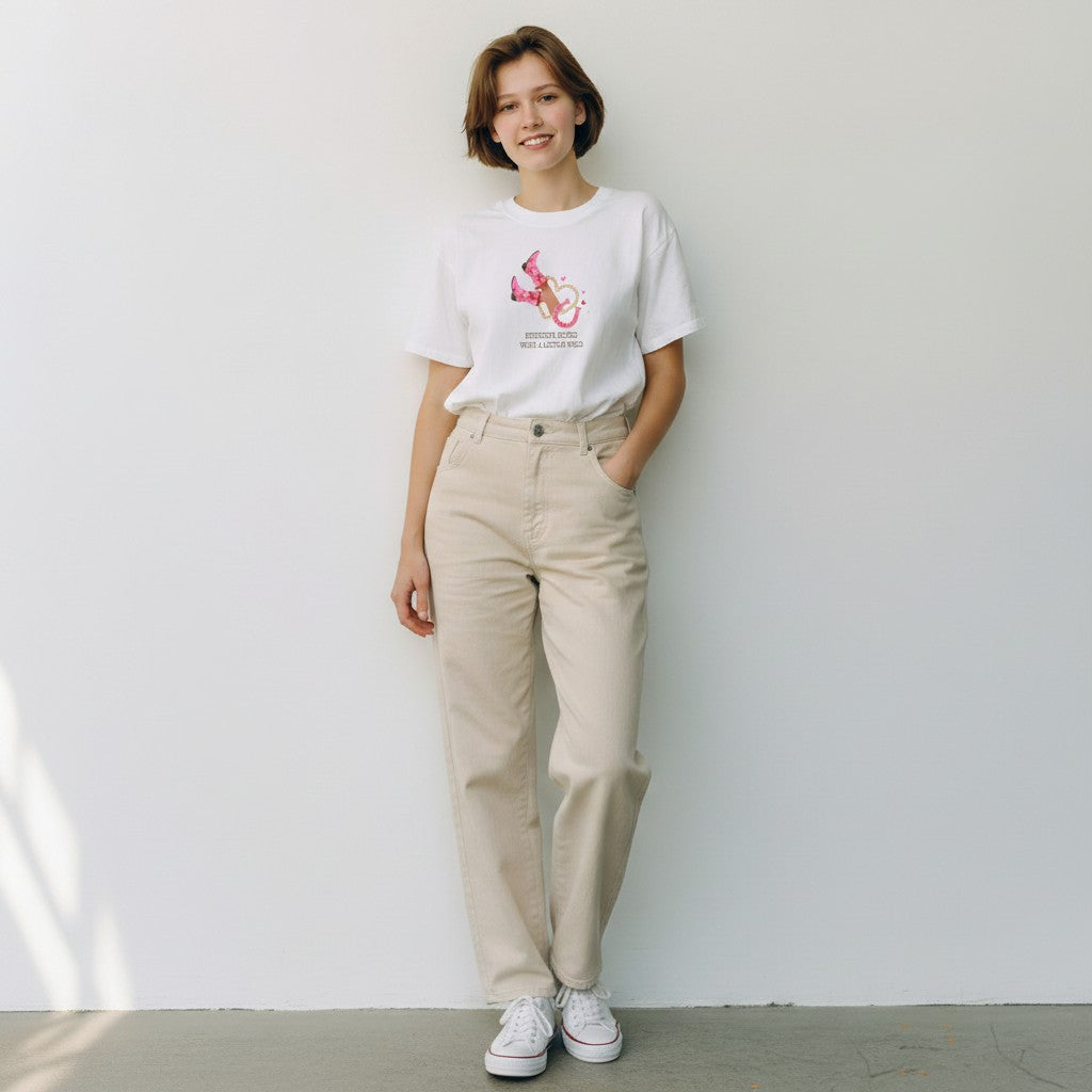 Jena Jewelry white cotton graphic tee with pink cowboy boots, lasso, and hearts graphic. Text reads 'Sunshine Mixed With A Little Wild'.