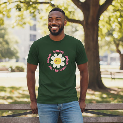 Jena Jewelry dark green 100% cotton t-shirt with a smiling daisy graphic and "Be the Reason Someone Smiles Today" text.