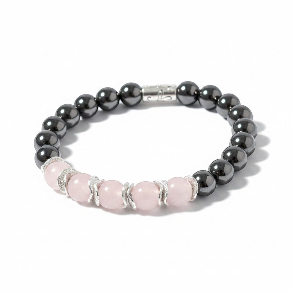 Jena Jewelry hematite and white quartz stretch bracelet with silver accents. Features dark grey, metallic hematite beads and pale pink quartz beads.