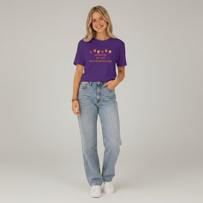 Jena Jewelry purple cotton t-shirt with "Kindness Is My Superpower" graphic and handprints.
