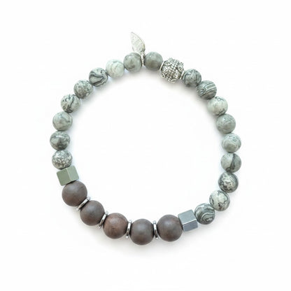 Jena Jewelry bracelet with grey speckled labradorite, ebony blackwood, and hematite beads, featuring a silver charm.