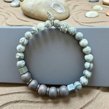 Jena Jewelry bracelet with grey Labradorite, Hematite, and Ebony Blackwood beads, silver charm, and cube accents.