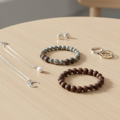 Jena Jewelry bracelet with grey labradorite, dark ebony wood beads, and hematite accents on a wrist.