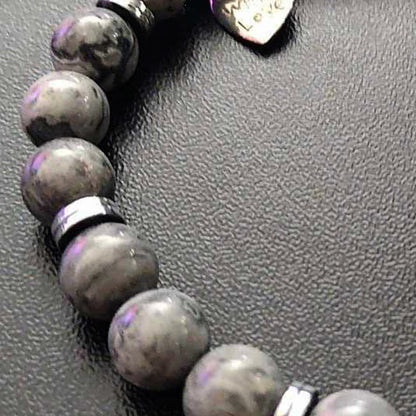 Jena Jewelry stretch bracelet with grey labradorite beads and hematite disk, featuring a small heart charm engraved with "Made With Love".