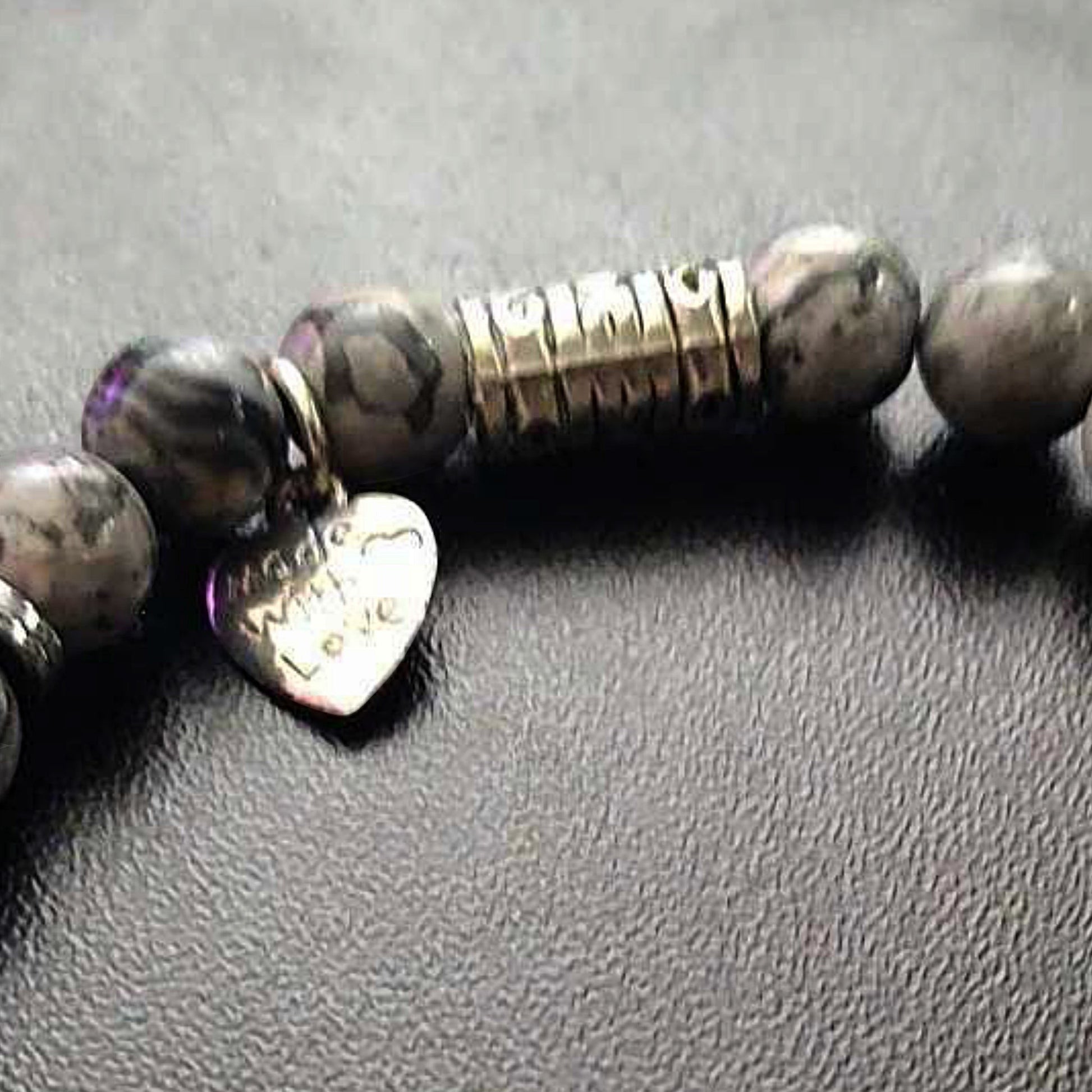 Jena Jewelry stretch bracelet with grey labradorite beads, hematite disk, and a silver heart charm inscribed "Made With Love".