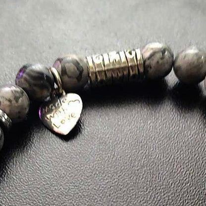 Jena Jewelry stretch bracelet with grey labradorite beads, hematite disk, and a silver heart charm inscribed "Made With Love".