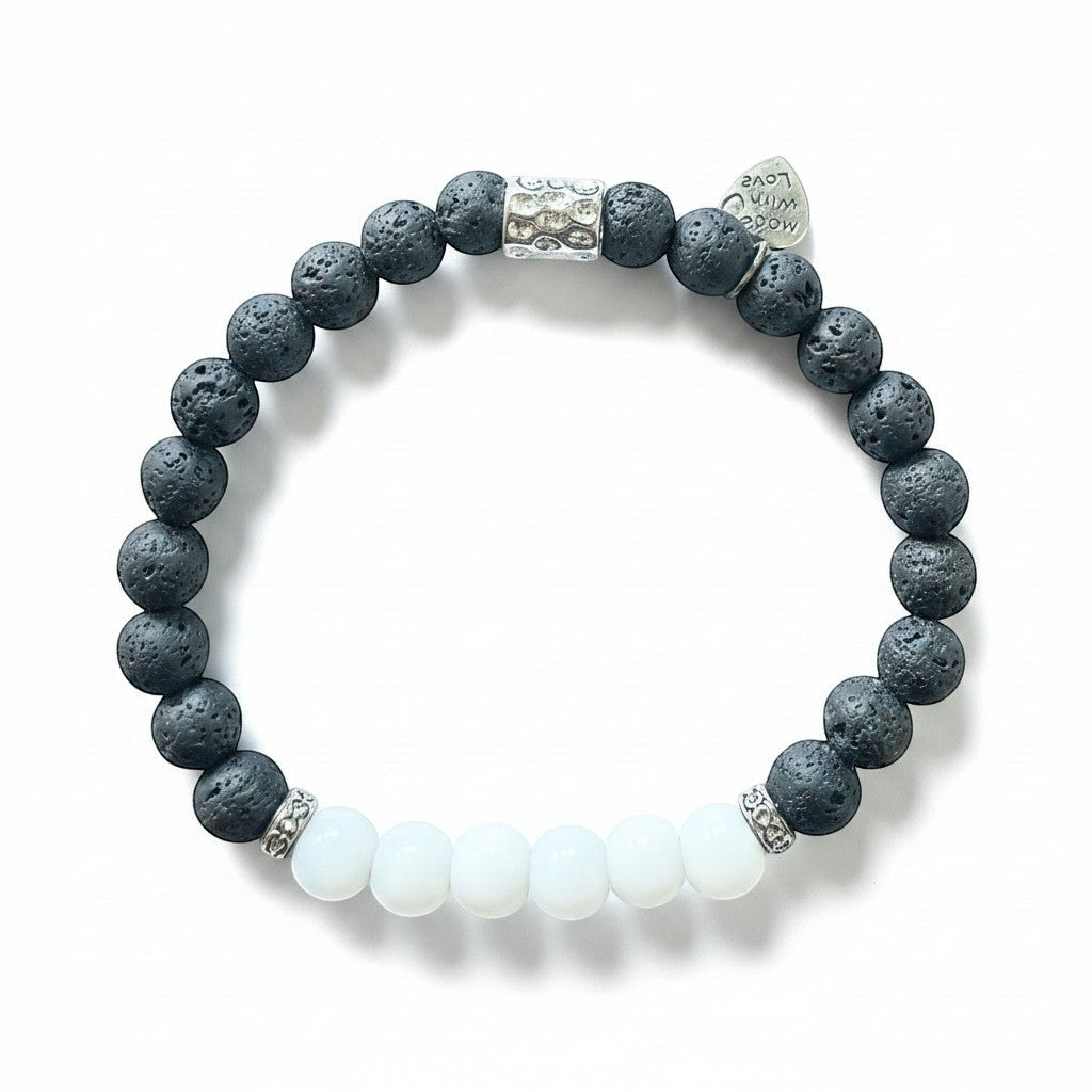 Jena Jewelry stretch bracelet with black lava stone beads, white jade beads, and silver accents. Includes a small heart charm.