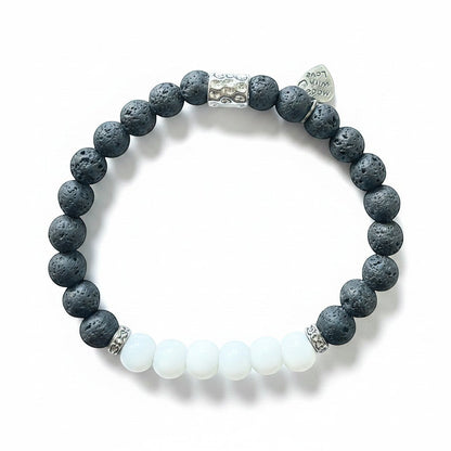 Jena Jewelry stretch bracelet with black lava stone beads, white jade beads, and silver accents. Includes a small heart charm.