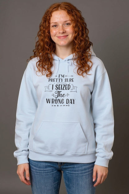 Light blue cotton-poly blend hoodie with a funny quote "I’m Pretty Sure I Seized the Wrong Day" printed on the chest. Features a kangaroo pocket and hood.