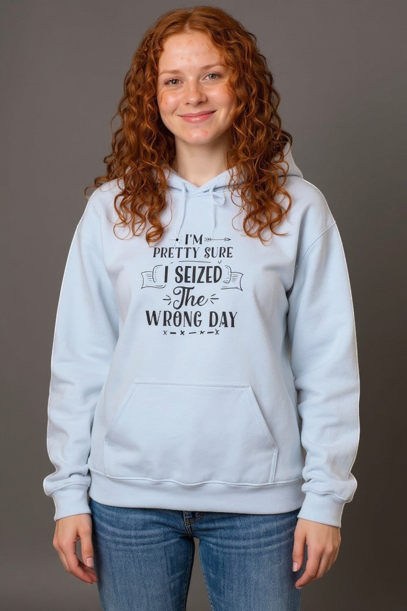 Light blue cotton-poly blend hoodie with a funny quote "I’m Pretty Sure I Seized the Wrong Day" printed on the chest. Features a kangaroo pocket and hood.